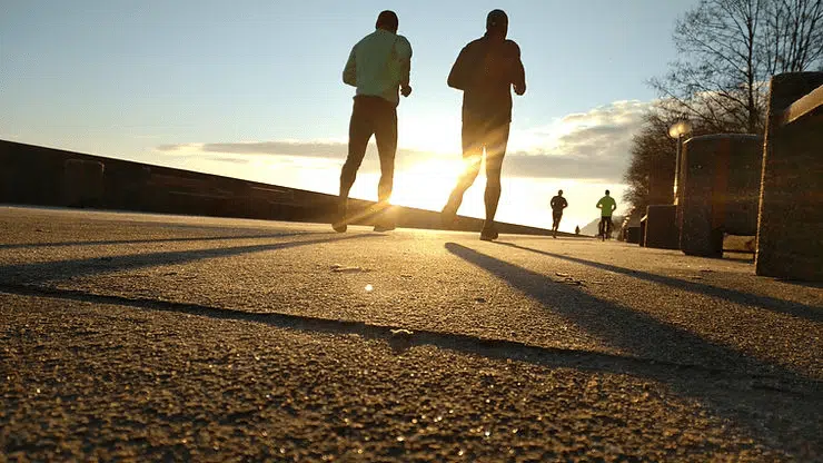 People exercising together during golden hour in outdoor setting