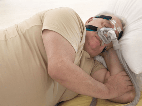Senior man sleeping soundly with CPAP machine nightly